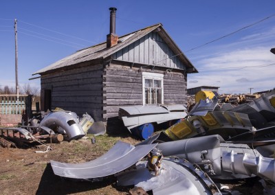 Dolgoshechelye village. Mezen restricted area.Parts of rockets scattered in the backyard of a craftsman who recovers and recycles them.The external parts of a rocket are entirely recycled and used to build boats and sleds. A rocketa is sold for around 150000 rubles.